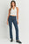 Woman wearing a white halter top and blue jeans on a white background