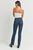 Woman wearing blue jeans and a white top on a plain background